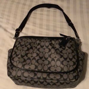 Grey and Black Coach diaper bag.